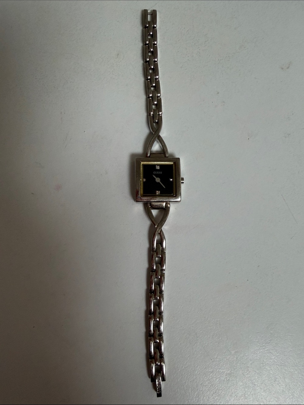 GUESS Silver Bracelet Watch with Black Dial and Gold Accents needs battery